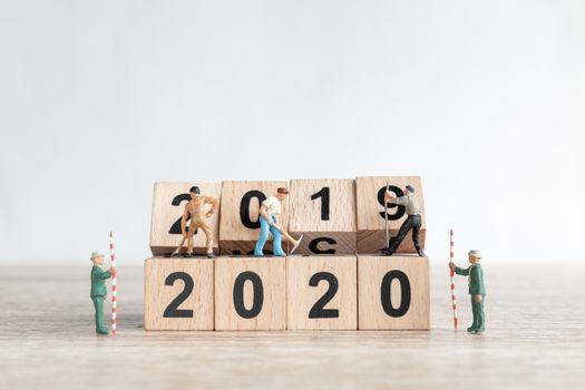 Miniature worker team create number 2020 and remove number 2019  , Happy new year 2019 concept