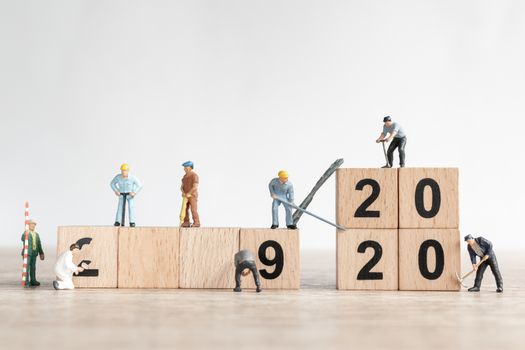 Miniature worker team create number 2020 and remove number 2019  , Happy new year 2019 concept