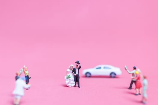 Miniature people wedding , Bride and groom on pink background , Valentine's day concept