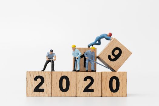Miniature people : Worker team create wooden block number 2020  , Happy new year concept