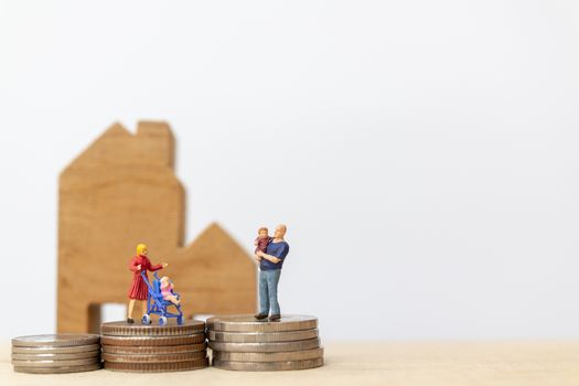 Miniature people : Parents with children with house and Coins Stacking  , Happy family concept