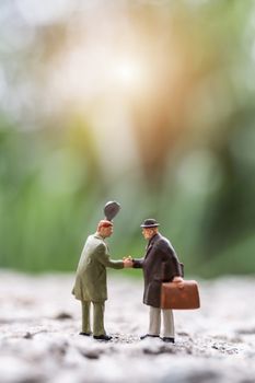 Miniature people : Business people meeting greeting shaking hands outdoor scene , Connecting People concept