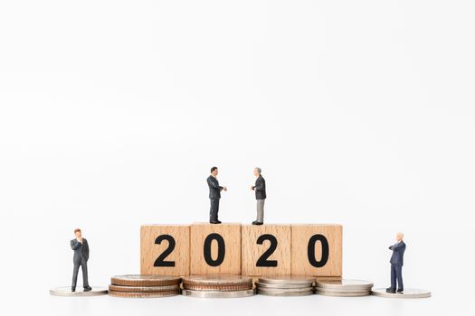 Miniature people : Business people standing on wooden block number 2020  , Happy new year concept