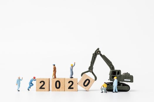 Miniature people : Worker team create wooden block number 2020  , Happy new year concept
