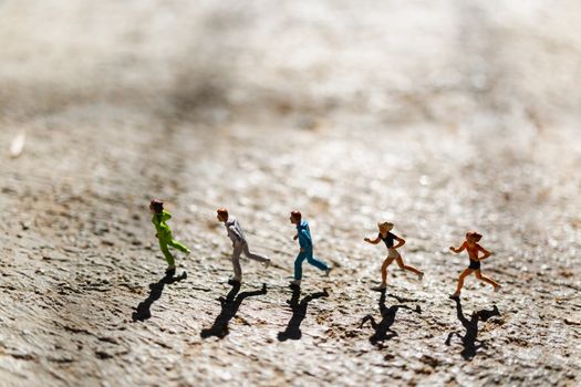 Miniature people : Group of people are running  on concrete floor ,  Healthy and lifestyle concept
