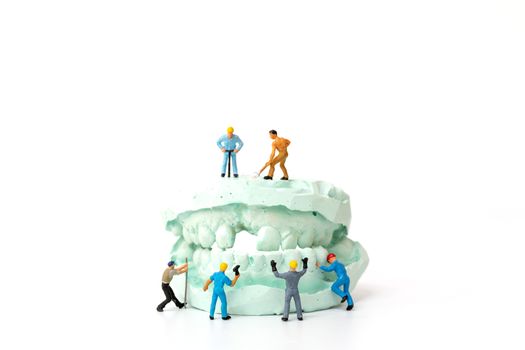 Miniature people : Worker team repairing a tooth ,Healthcare and medical concept