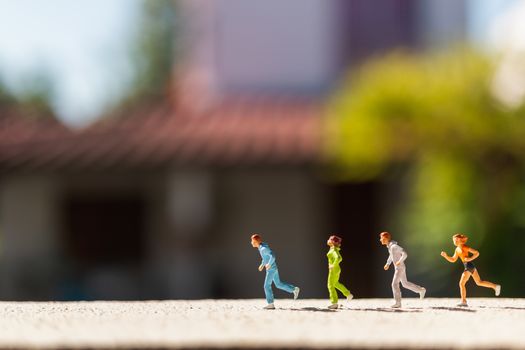 Miniature people : Group of people are running  on concrete road ,  Healthy and lifestyle concept