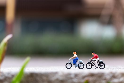 Miniature people travellers with bicycle in the park , Healthy lifestyle concept