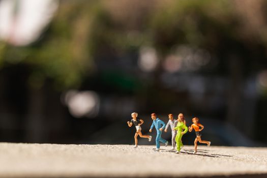 Miniature people : Group of people are running  on concrete road ,  Healthy and lifestyle concept
