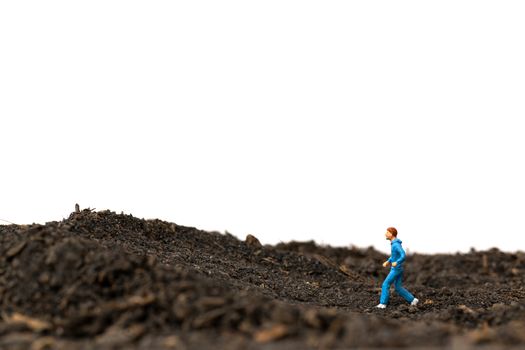 Miniature people : Man Running on The ground  isolated on white background , Run for health concept.