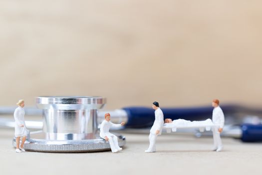 Miniature people : Doctor with nurse carry the patient on a stretcher. Healthcare  concept.