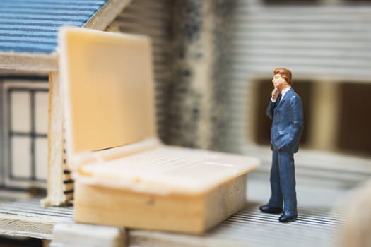 Miniature people business man working with computer labtop , Work at home concept