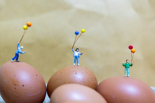 Miniature people : Happy family holding balloon celebrating Easter eggs