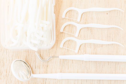 Oral Device : A box of white dental floss on wooden background