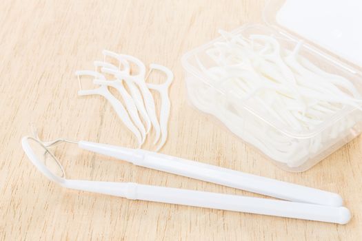 Oral Device : A box of white dental floss on wooden background