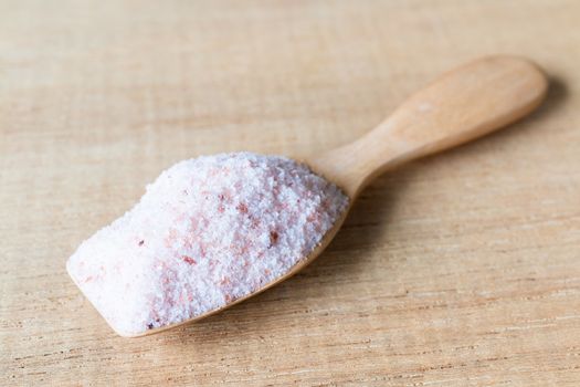 Pink salt , Himalayan salt on wooden background