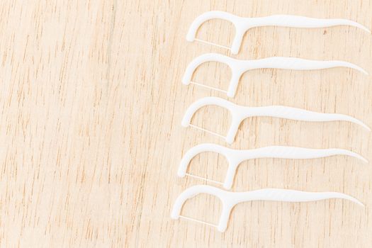 Oral Device : Dental floss on wooden background