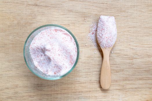 Pink salt , Himalayan salt on wooden background