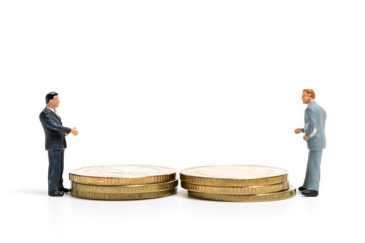 Miniature people: Businessman standing on stack of coin , Money and financial concepts.