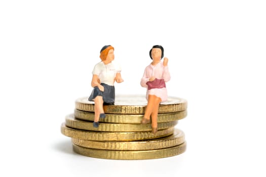 Miniature people: Businessman sitting on stack of coin , Money and financial concepts.