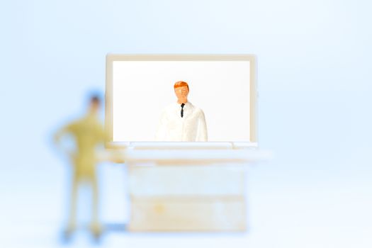 Miniature people , Male patient talk consult with doctor using video call on laptop , online doctor concept