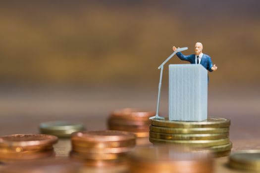 Miniature people : Businessman speaking on the podium , Business and finance investment concept