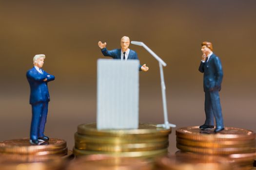 Miniature people : Businessman speaking on the podium , Business and finance investment concept