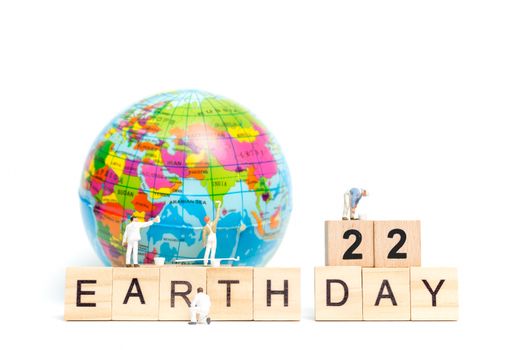 Miniature people : Painters painting on The globe on white background , Earth day concept