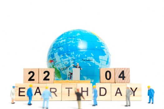 Miniature people : Businessman speaking on the podium , Earth day concept