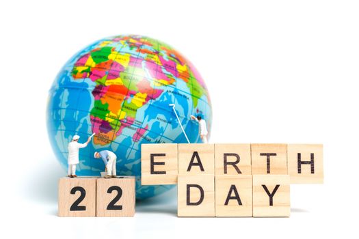 Miniature people : Painters painting on The globe on white background , Earth day concept