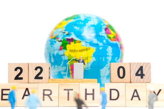 Miniature people : Businessman speaking on the podium , Earth day concept