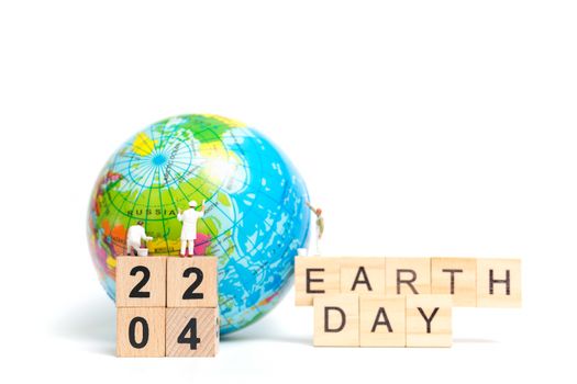 Miniature people : Painters painting on The globe on white background , Earth day concept