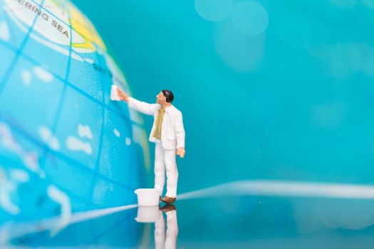 Miniature people : Painters painting on The globe  background , Earth day concept