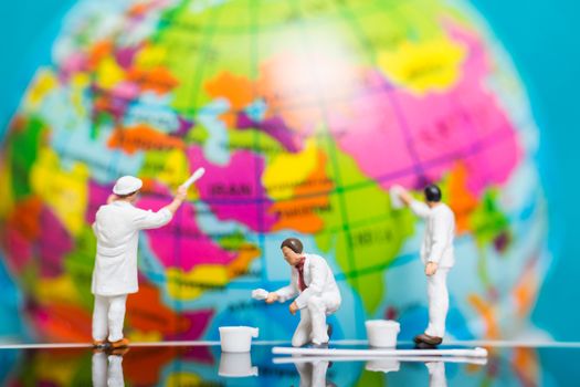 Miniature people : Painters painting on The globe  background , Earth day concept