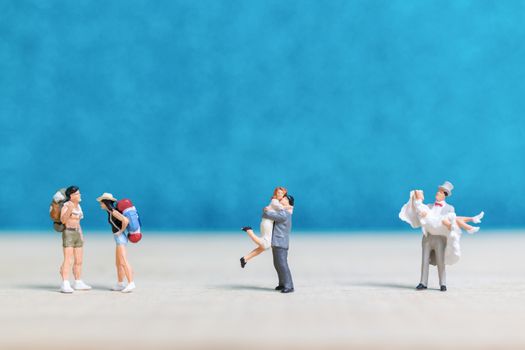 Miniature people : Bride and groom , Couple  on blue background.