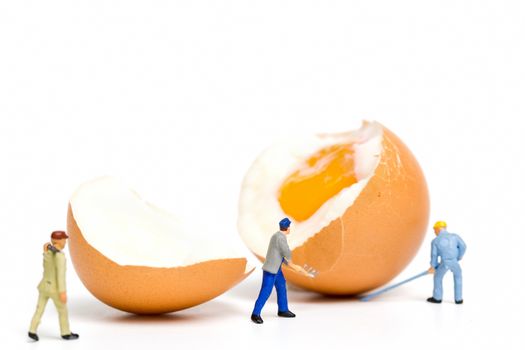 Miniature people work at Easter-eggs for Easter day on white background