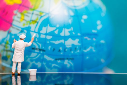 Miniature people : Painters painting on The globe  background , Earth day concept