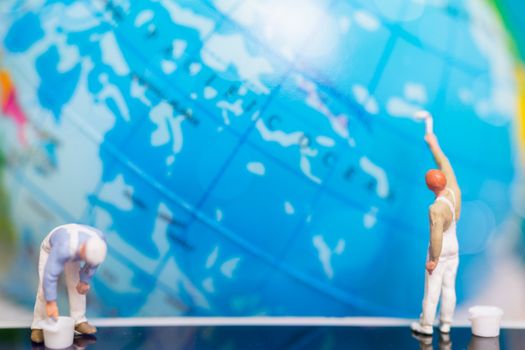 Miniature people : Painters painting on The globe  background , Earth day concept