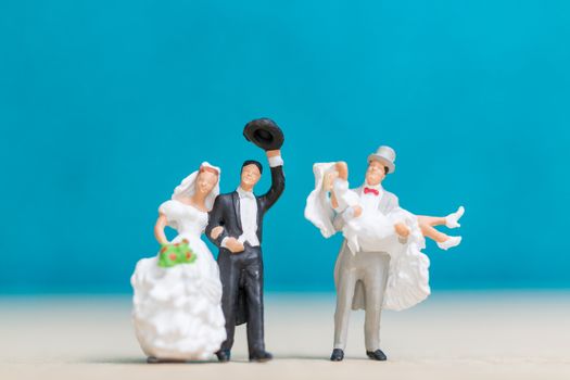 Miniature people : Bride and groom , Couple  on blue background.