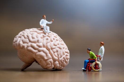 Miniature people, Surgeon spoke with patient about brain injuries. Medical healthcare and surgical doctor service concept.