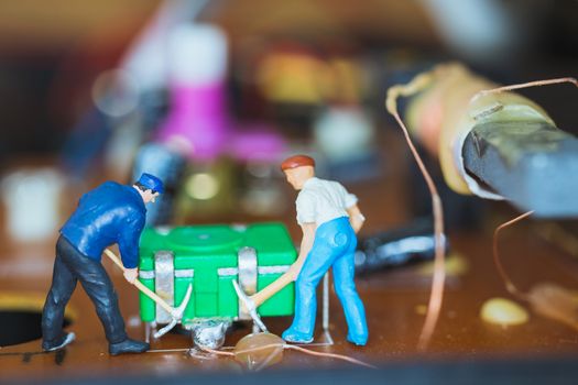 Miniature people : Worker team repairing Electronic Circuits. , Construction workers concept