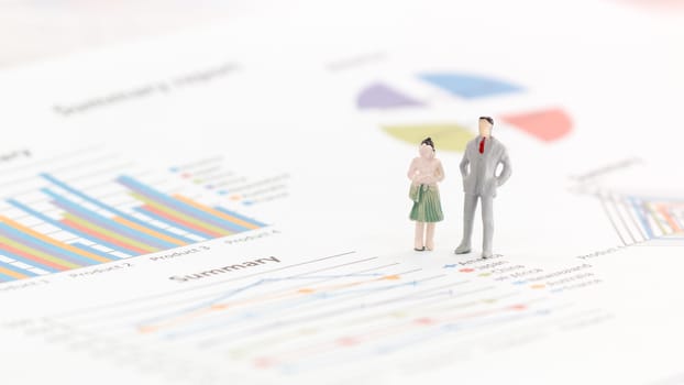 Miniature figures businessman standing on a graph chart