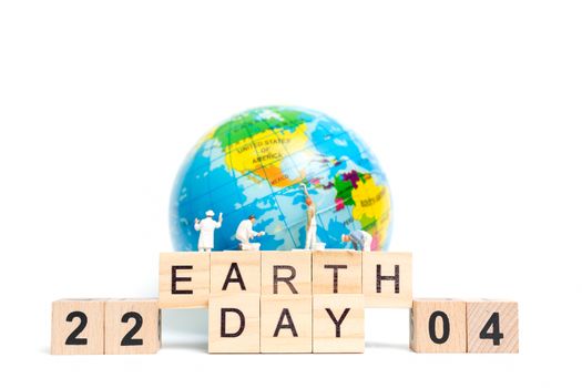 Miniature people : Painters painting on The globe on white background , Earth day concept