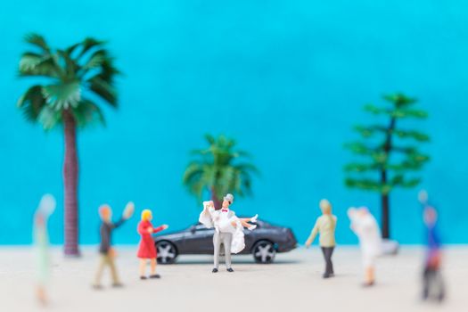 Miniature people, Bride and groom on the beach , Wedding concept