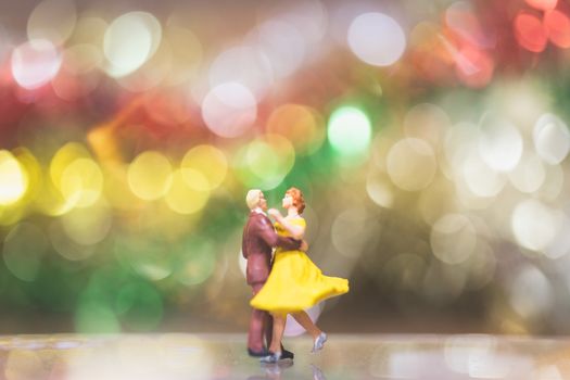 Miniature people : Couple romantic dancing with Bokeh background ,Nightlife and people concept