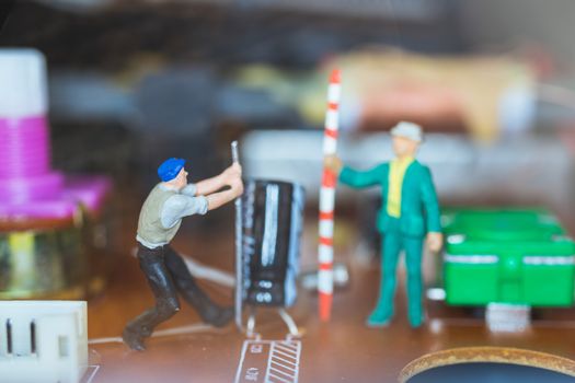 Miniature people : Worker team repairing Electronic Circuits. , Construction workers concept