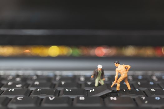 Miniature people : Worker team of engineers repairing keyboard computer laptop. Computer repair concept.