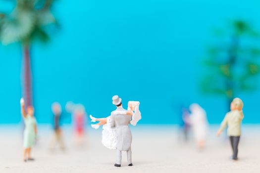 Miniature people, Bride and groom on the beach , Wedding concept