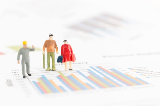 Miniature figures businessman standing on a graph chart
