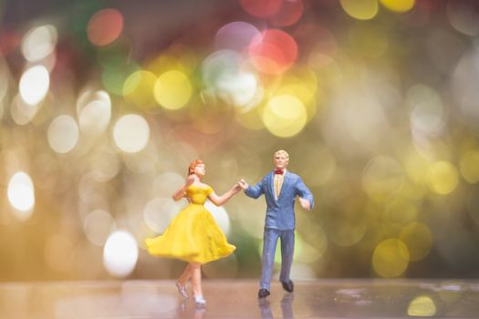 Miniature people : Couple romantic dancing with Bokeh background ,Nightlife and people concept